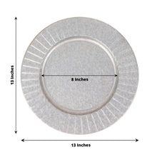 A silver metal charger plate with measurements of 13 inches and 8 inches