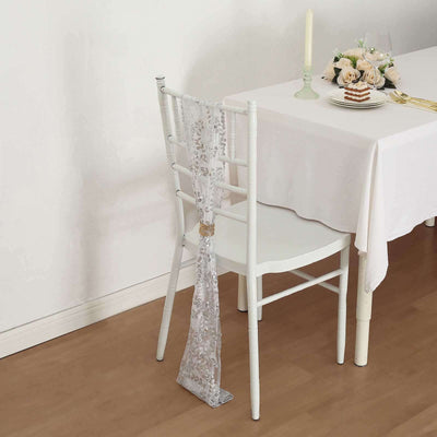 Elegant silver table runner draped on a white chair at a dining table.