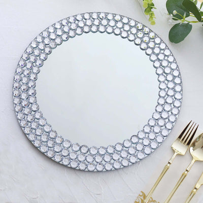 Round mirrored platter with crystal accents on a white background.
