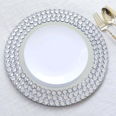 Elegant round mirror charger plate with crystal accents for table decor.