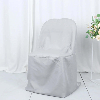 Gray chair cover on a plain backdrop for event decoration.