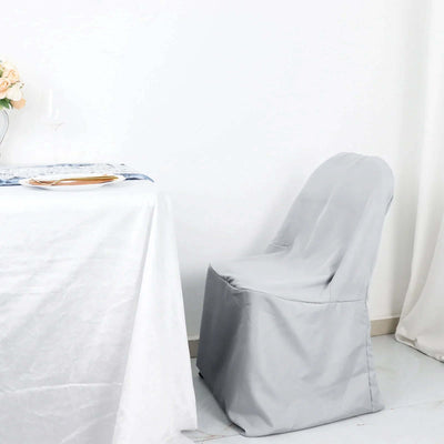 Elegant gray chair cover on a dining chair beside a table.