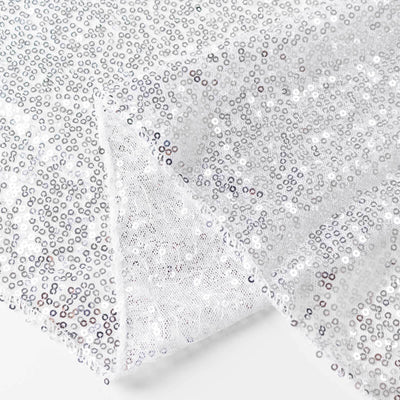 Silver sequin fabric with a shimmering finish, perfect for crafts and decor.
