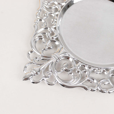 Silver ornate mirror with decorative border design.