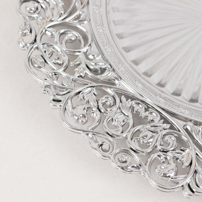 Ornate silver decorative platter with intricate detailing.