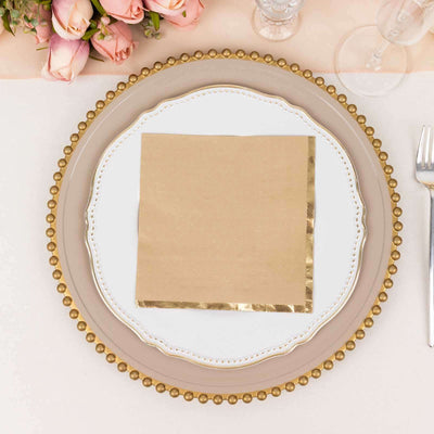 Elegant table setting with a gold-beaded plate and a folded napkin.