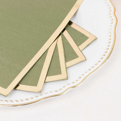 Green stationery with gold borders arranged on an elegant plate.