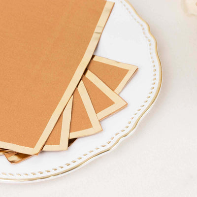 Brown paper sheets with gold edges on a decorative plate.