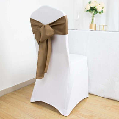 White chair cover with brown sash, perfect for event decor.