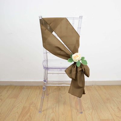 Brown chair sash with rose embellishment on a clear chair