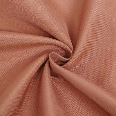 Close-up of soft, textured fabric in warm peach color.