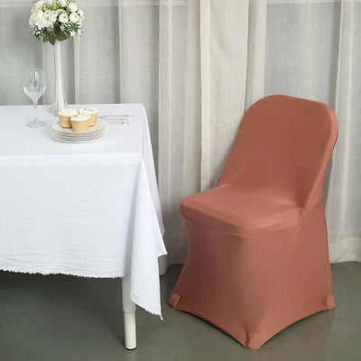Elegant peach chair cover draped over a chair beside a dining table.