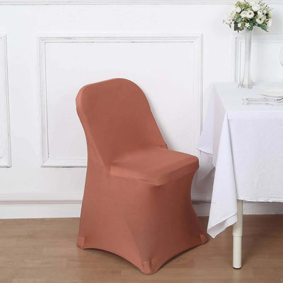 Elegant terracotta chair cover draped over a chair in a stylish dining setup.