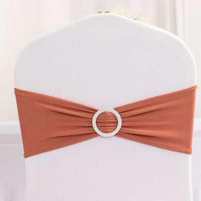 Rustic orange chair sash with rhinestone buckle on a white chair