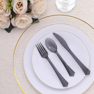 Elegant black plastic cutlery set on a decorative plate with floral accents.