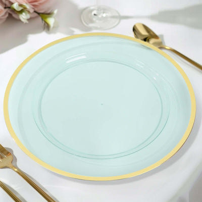 Mint green plate with gold rim on a table setting.
