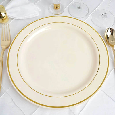 Elegant cream dinner plate with gold trim on a textured table setting.