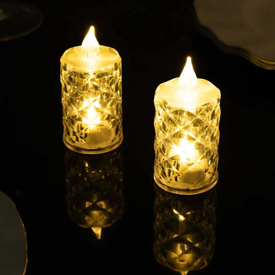 Decorative LED candles with a crystal design, glowing warmly in a dark setting.