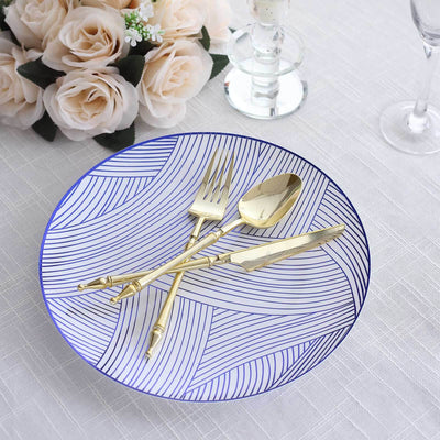 Gold cutlery on a decorative blue and white plate with a floral backdrop.