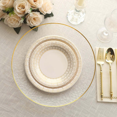 Elegant dinnerware set with gold accents on a textured tablecloth.