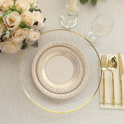 Elegant dinner setting with decorative plates, glassware, and floral arrangement.