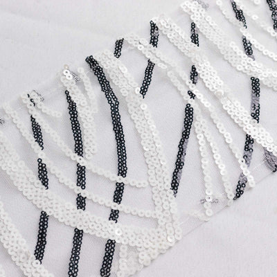 Decorative black and white sequin fabric with intricate patterns.