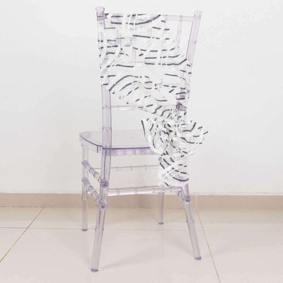 Clear acrylic chair with a stylish zebra print draped over it.