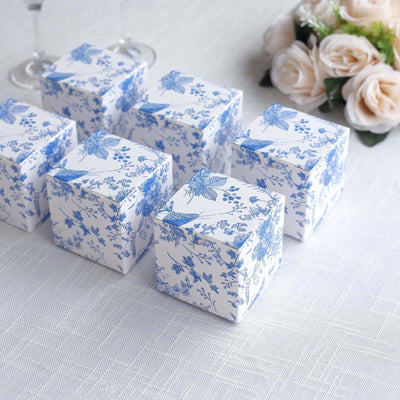 Blue floral gift boxes arranged elegantly on a table.
