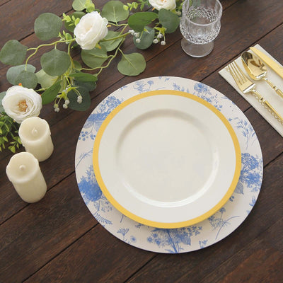 Elegant table setting with floral plates and gold cutlery.