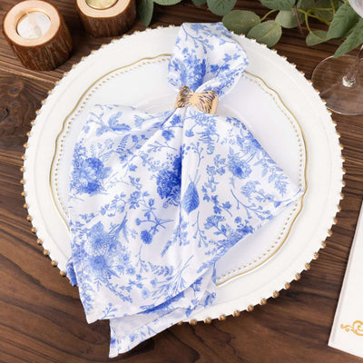 Blue floral napkin elegantly styled on a decorative plate.