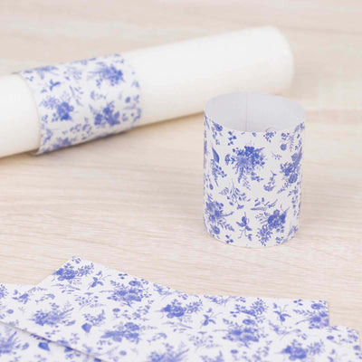 Floral patterned wrapping paper and tube on a wooden surface.