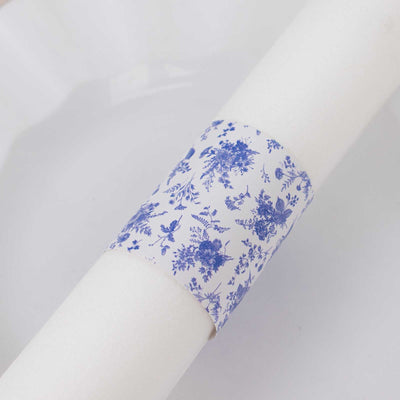 Blue floral napkin ring on a white napkin.