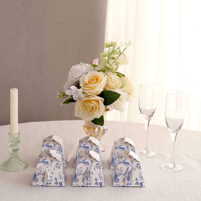 Decorative floral gift boxes arranged on a table with a bouquet and champagne flutes.