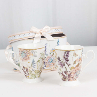 Floral patterned mugs beside a decorative storage box.