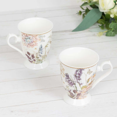 Floral-patterned ceramic mugs on a wooden surface.