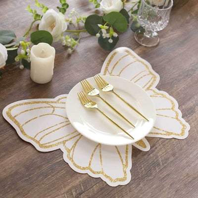 Butterfly-shaped placemat with gold accents, white plate, and gold utensils