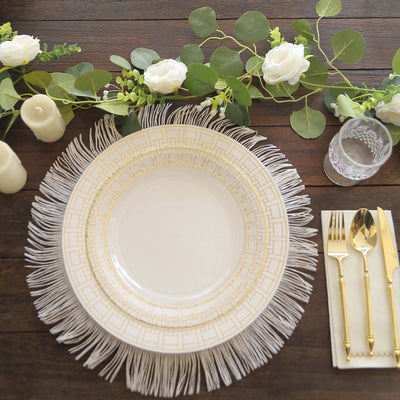 Elegant dining plate with fringe detail, surrounded by greenery and candles.