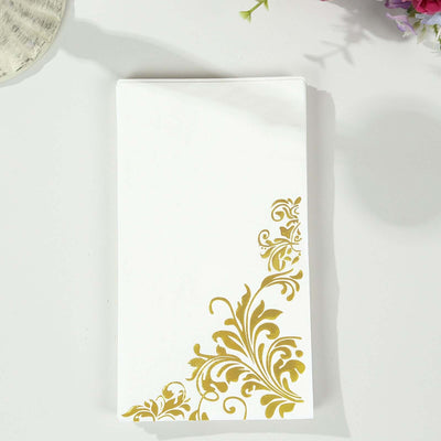 White napkin with gold floral design in the corner