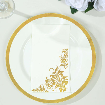 Gold-accented napkin on elegant white plate with floral design.