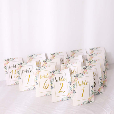 Floral table number cards for weddings or events, featuring elegant gold lettering.