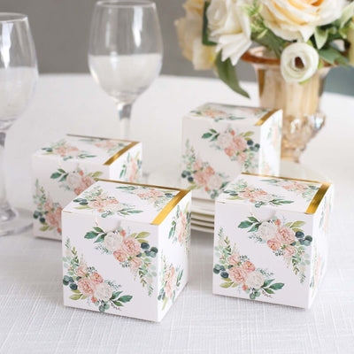 Floral gift boxes on a table setting with elegant decor.
