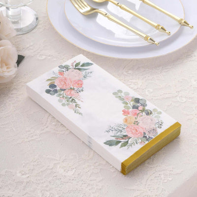 Floral-themed napkins with gold accents on a lace table setting.