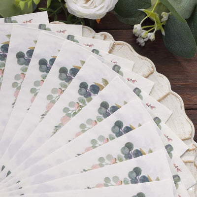 Floral-patterned paper fan arranged in a circular display on a wooden surface.