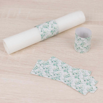 Floral patterned wrapping paper roll with matching gift tags on a wooden surface.