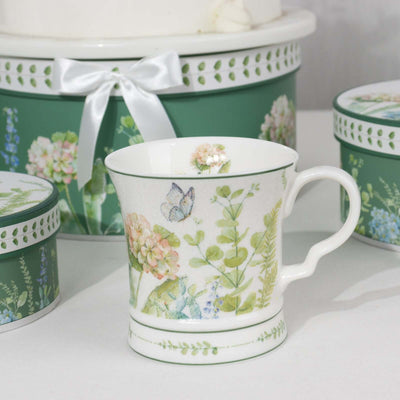Floral ceramic cup with butterfly design, surrounded by decorative storage containers.