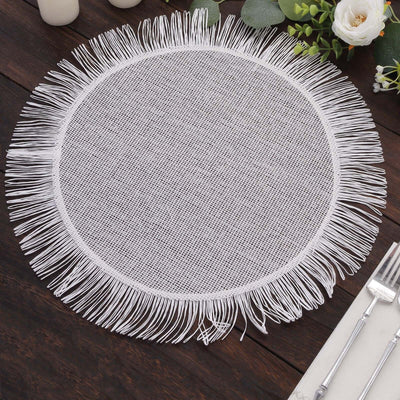 White round placemat with fringe detail on a wooden table.