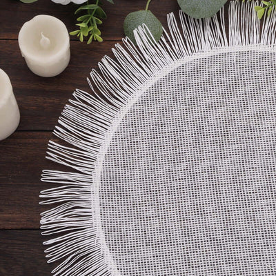 Round lace table runner with fringed edges on a wooden surface.