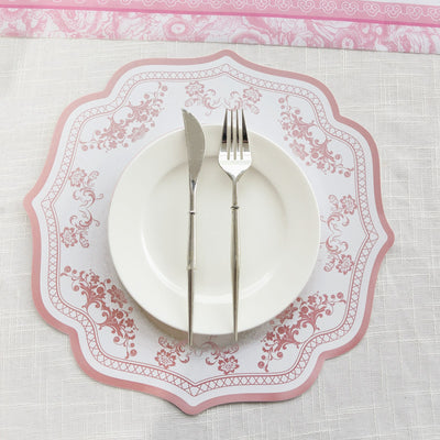 Elegant pink floral table setting with plate, knife, and fork.