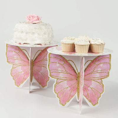 Butterfly-shaped cake and dessert stands with cupcakes and a cake
