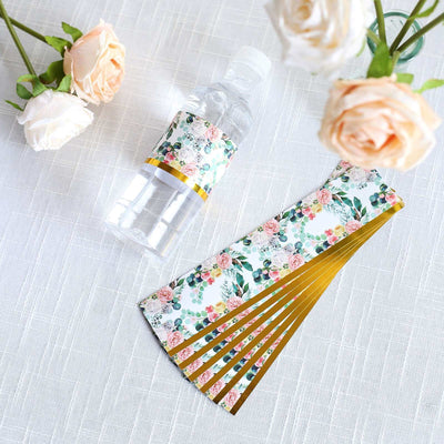 Floral water bottle with decorative fan on a light textured background.